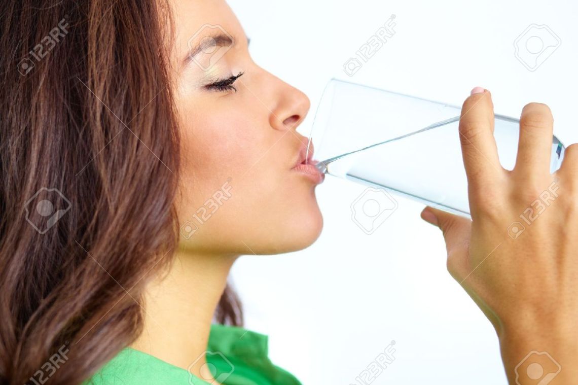 15978481-close-up-of-pretty-girl-drinking-water-from-glass-stock-photo